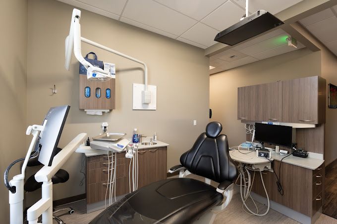 Modern dental treatment room with patient chair and equipment