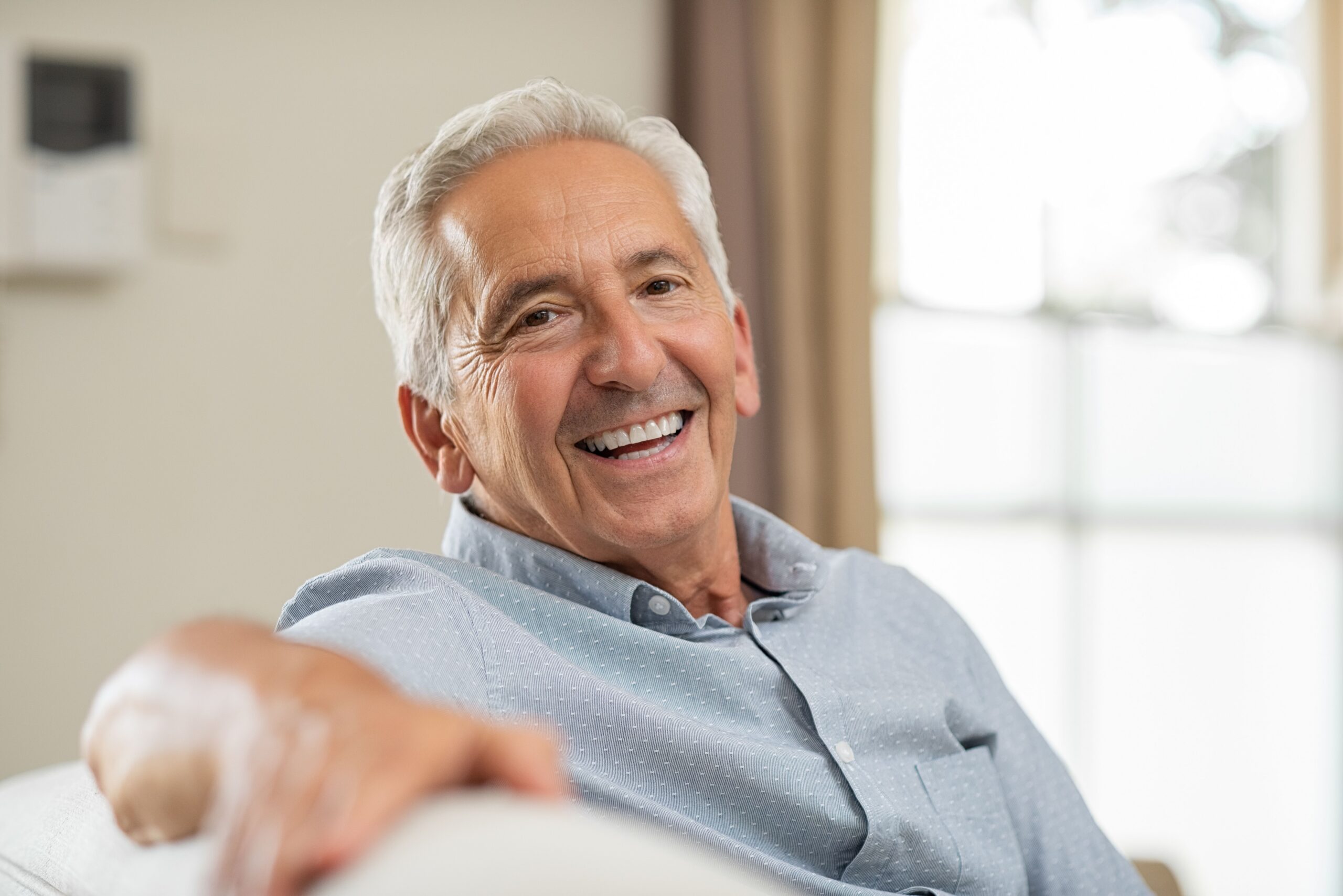 Older man relaxing at home with a healthy smile